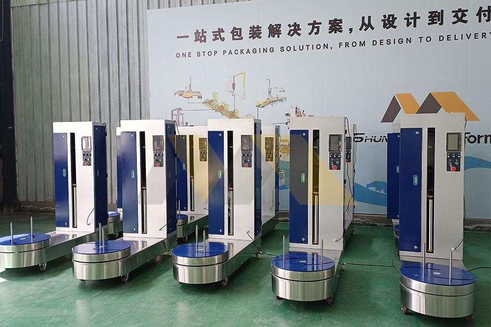Passenger using airport wrapping machine