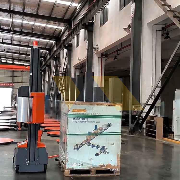 Factory worker operating automatic robot pallet wrapping machine